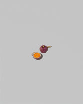View from the back of the Passion Fruit Charm on light color background.