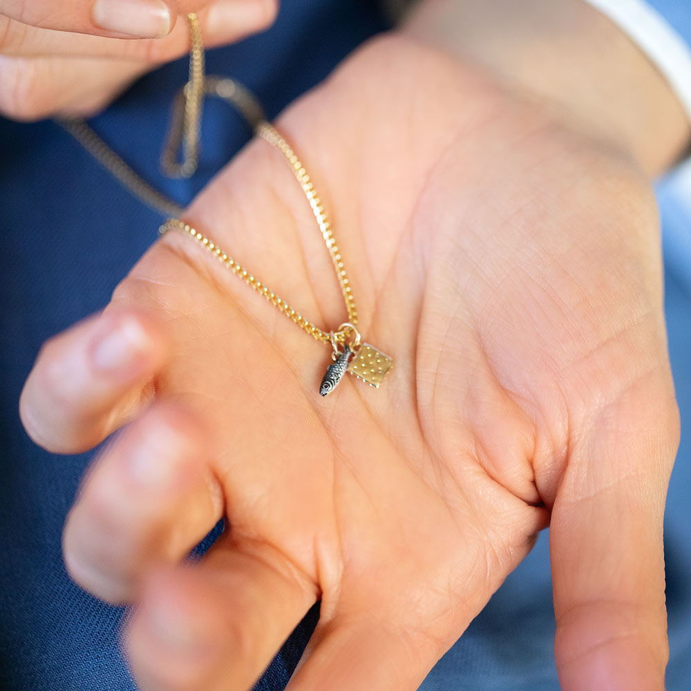 product_details::Sardine Charm, Saltine Cracker Charm and 1.5mm Ritual Chain Necklace on model.