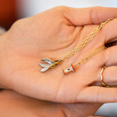 product_details::Hot Dog Chain Necklace with Bruised Banana Peel Charm, Red Apple Core Charm with Petite Diamond Cut Chain Necklace and Gold Bump Band on model.