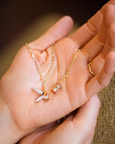 2.2mm Beveled Oval Chain Necklace with Banana Peel Charm, Red Apple Core Charm with Petite Diamond Cut Chain Necklace and Gold Bump Band on model.