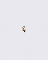 Gold Thousand & One Night Heart Charm on light color background.