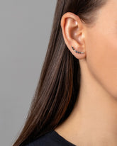 An edition of the Sapphire & White Diamond Crescent Ear Climber Stud Earrings on model.