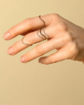 Gold Pavé Curve Bands on model.
