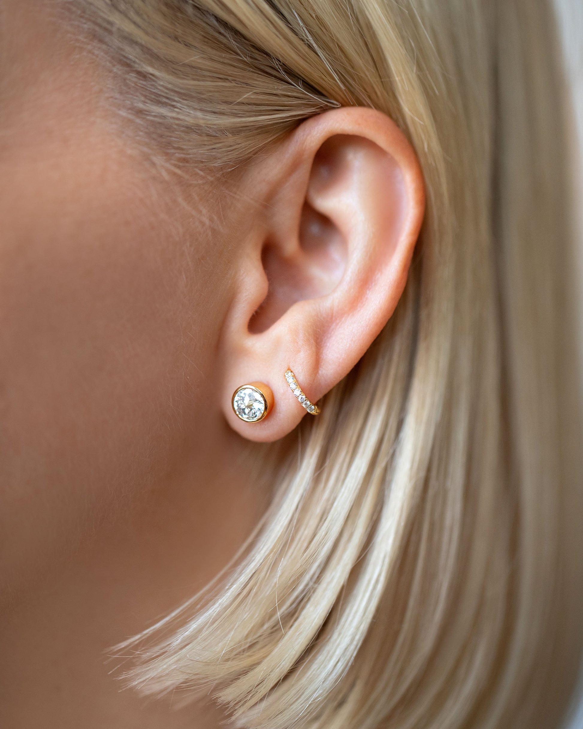 Allium Stud Earrings and Huggie Gold Diamond Snack Hoop Earrings on model.