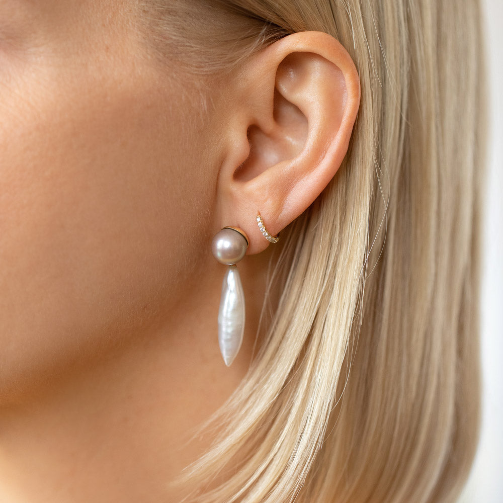product_details::Aphrodite Earrings and Huggie Diamond Snack Hoop Earrings on model.