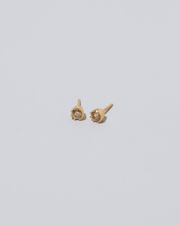 Champagne Diamond Sun & Moon Stud Earrings on light color background.