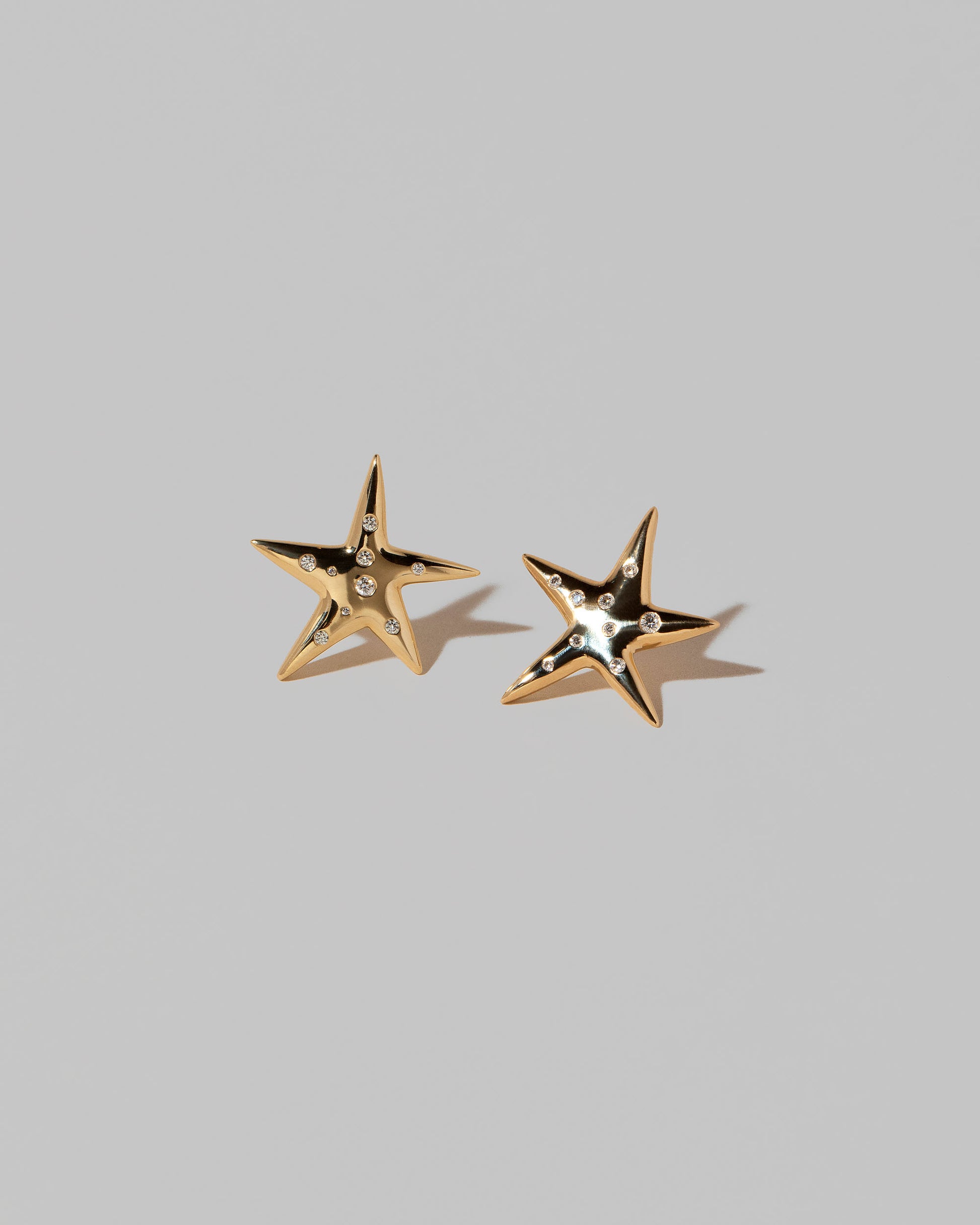 Verve Astral Star Stud Earrings on light color background.