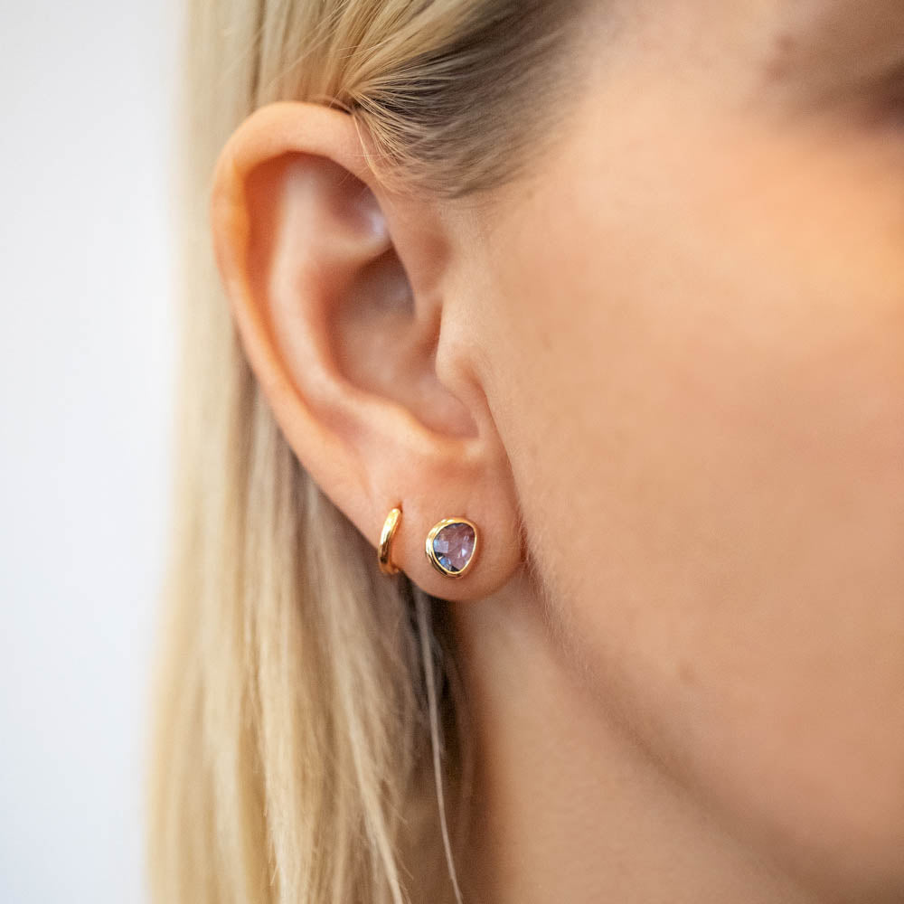 product_details::Gusher Blue Sapphire Stud Earrings 003 on model.