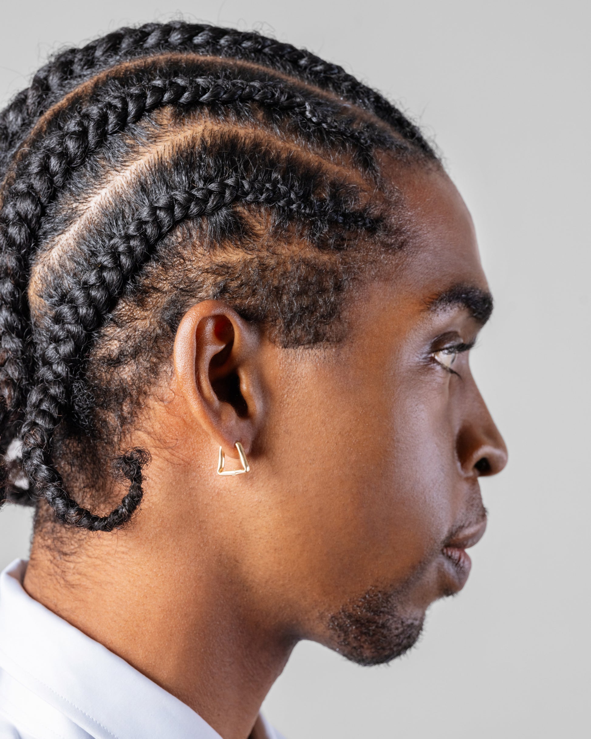 Gold Kink Hoop Earrings on male model.