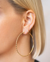 Large Pave Diamond Hoop Earrings and Huggie Gold Diamond Snack Hoop Earrings on model.