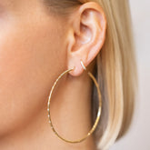 product_details::Large Pave Diamond Hoop Earrings and Huggie Gold Diamond Snack Hoop Earrings on model.