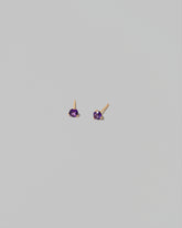 Petite Amethyst Martini Stud Earrings on light color background.