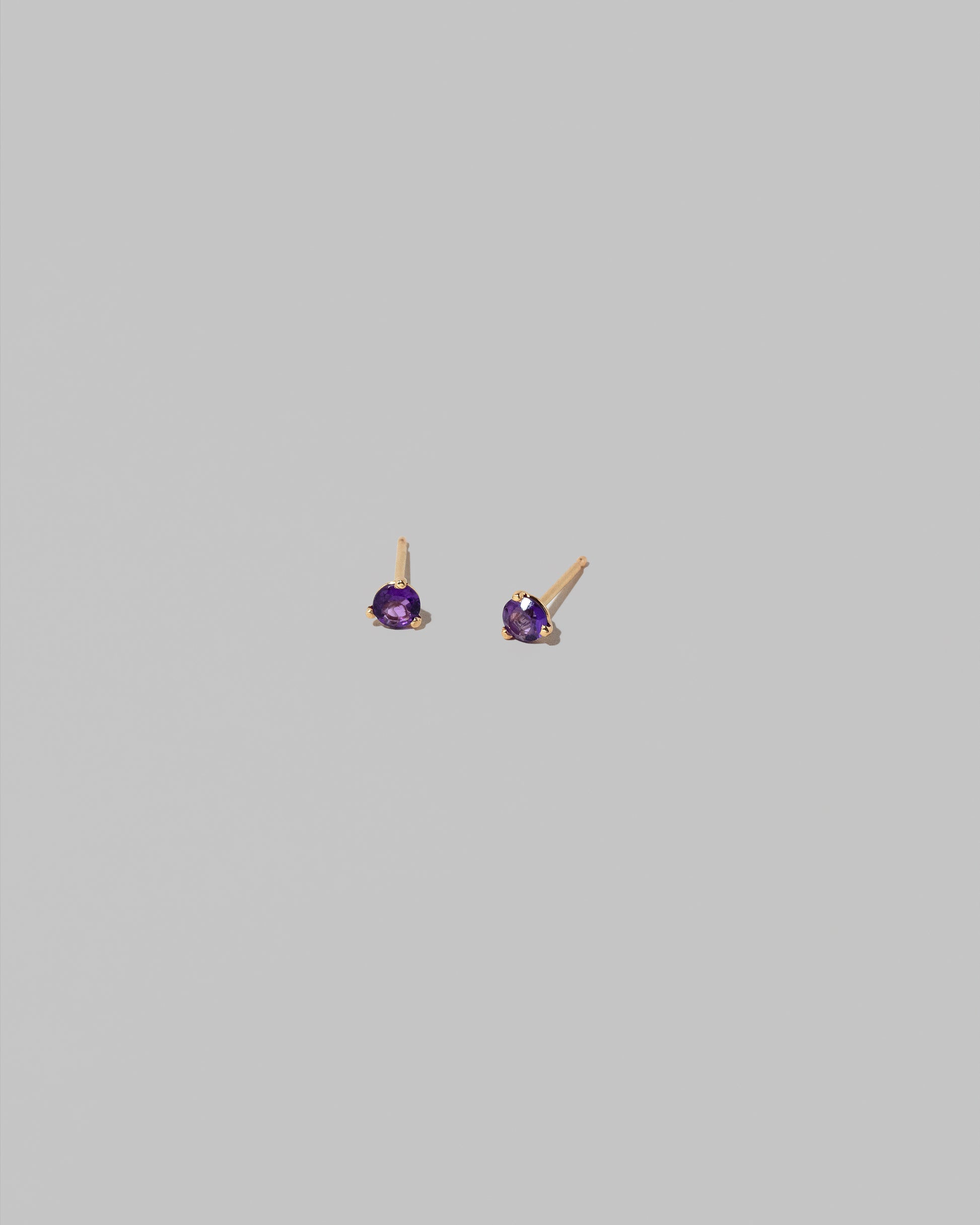Petite Amethyst Martini Stud Earrings on light color background.