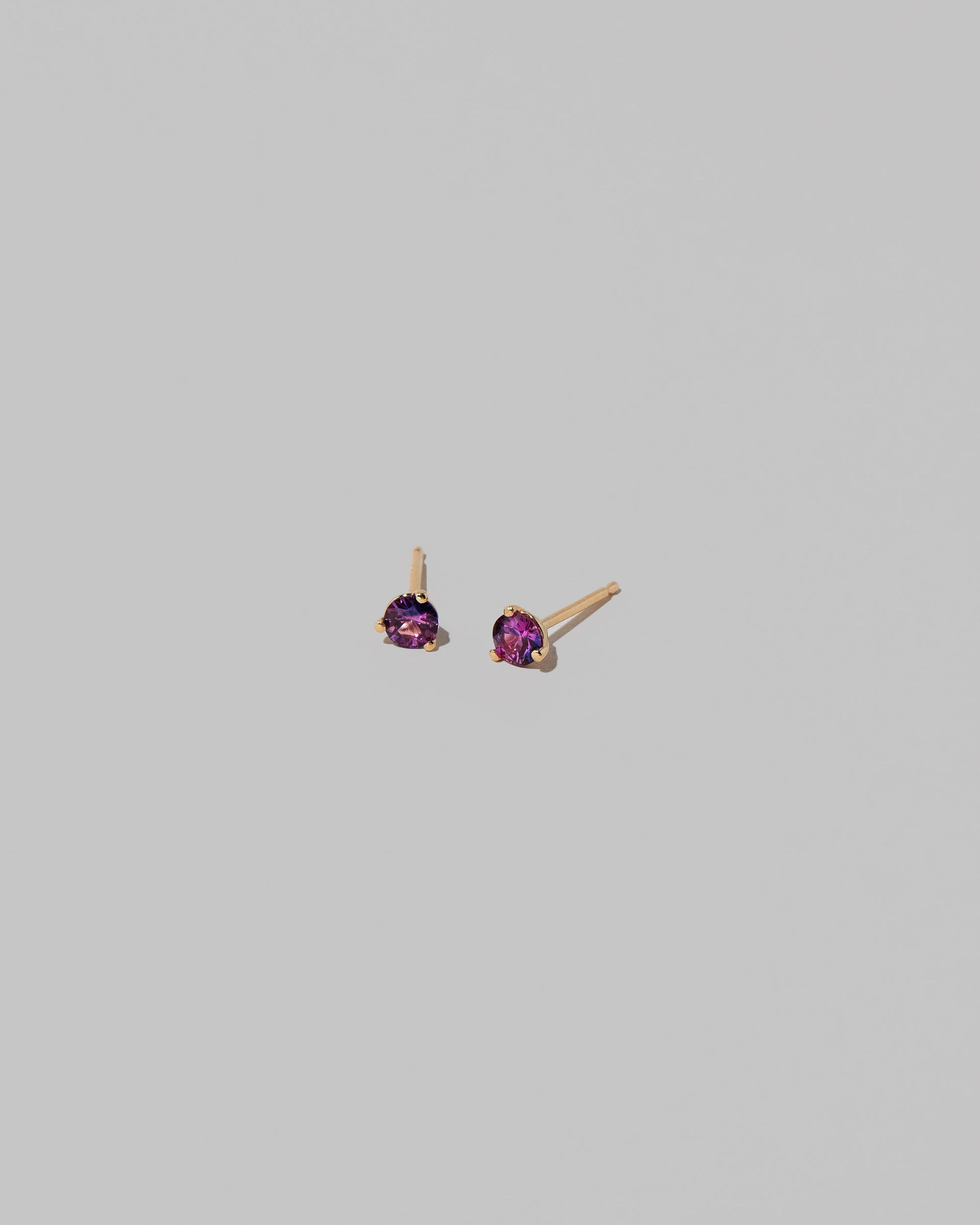 Petite Bicolor Purple Sapphire Martini Stud Earrings on light color background.
