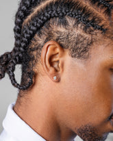 Grand White Diamond Martini Stud Earrings on male model.