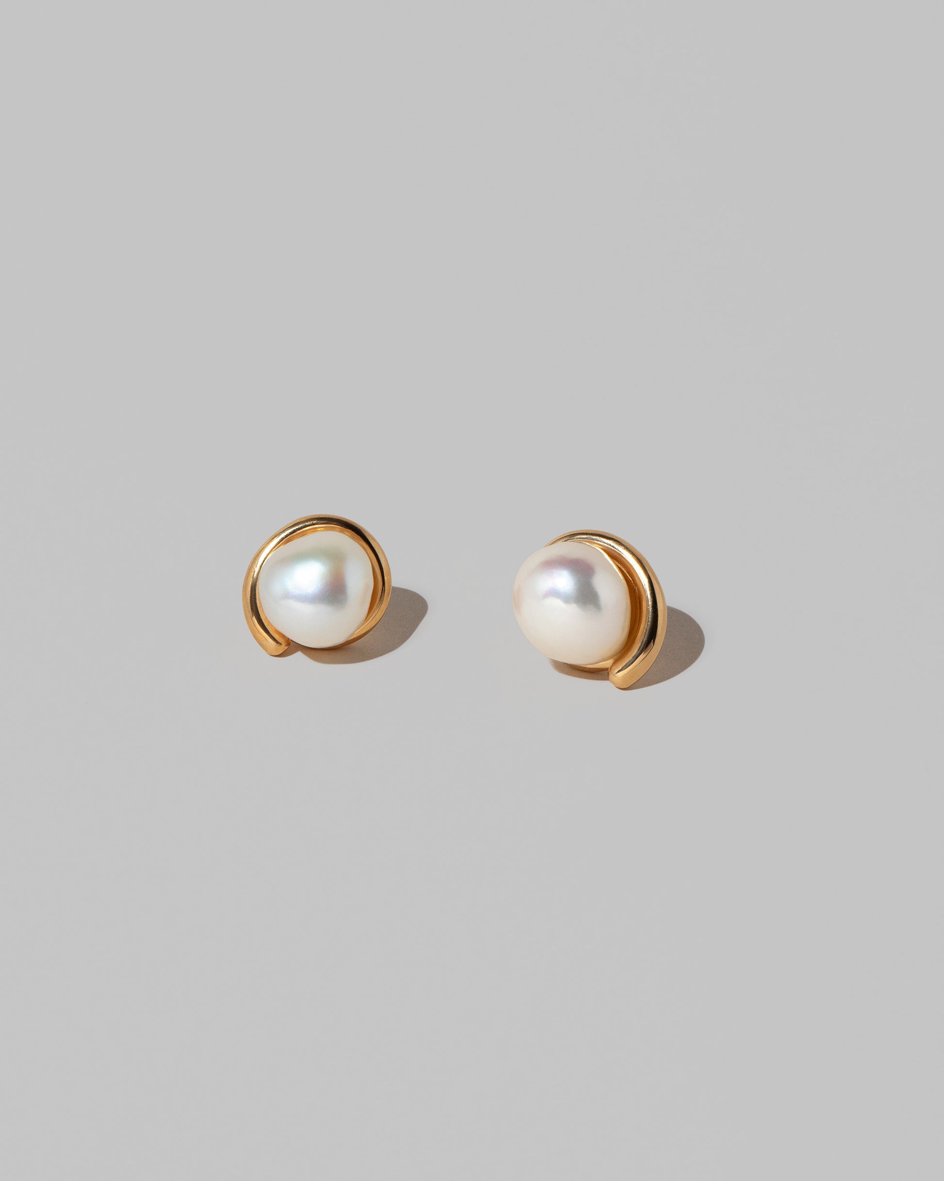 Nereus Earrings on light color background.