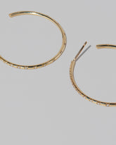 Closeup details of the Pave Diamond Hoop Earrings on light color background.