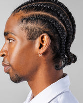 Gold Snow Flower Huggie Hoop Earrings on male model.