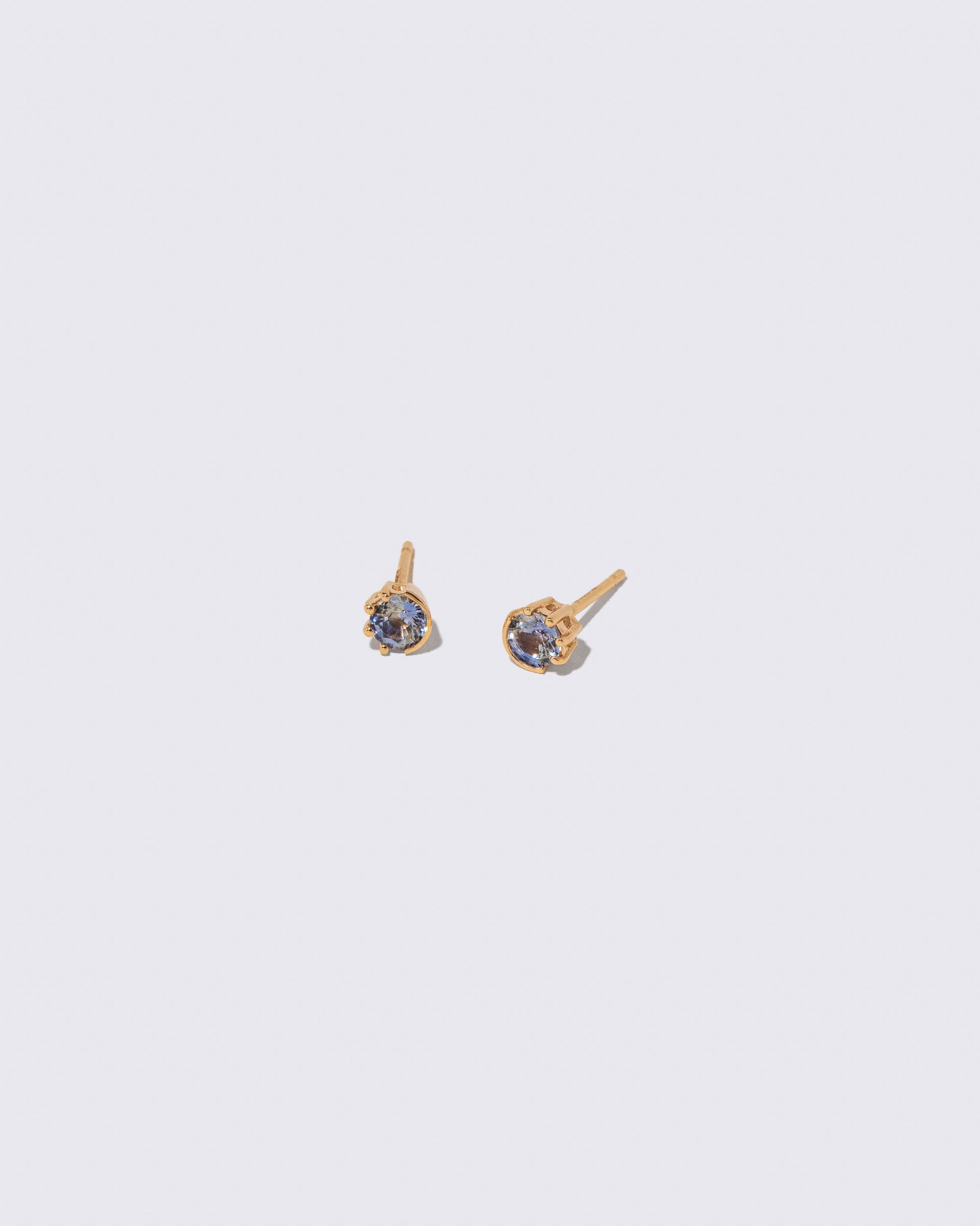 Bicolor Sapphire Sun & Moon Stud Earrings on light color background.
