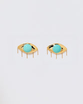 Turquoise Eye Earrings on light color background.