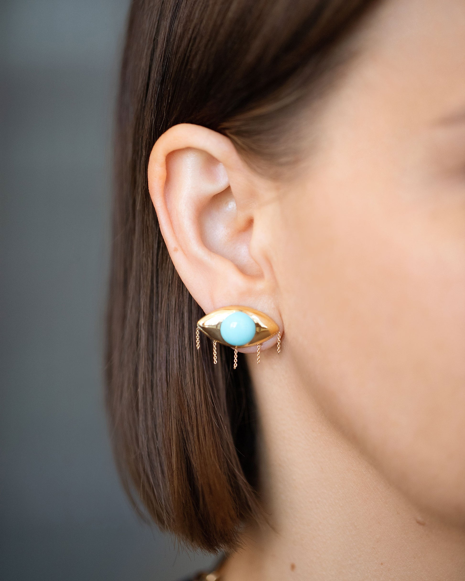 Turquoise Eye Earrings on model.