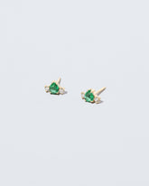 Emerald & Diamond Teardrop Earrings on light color background.