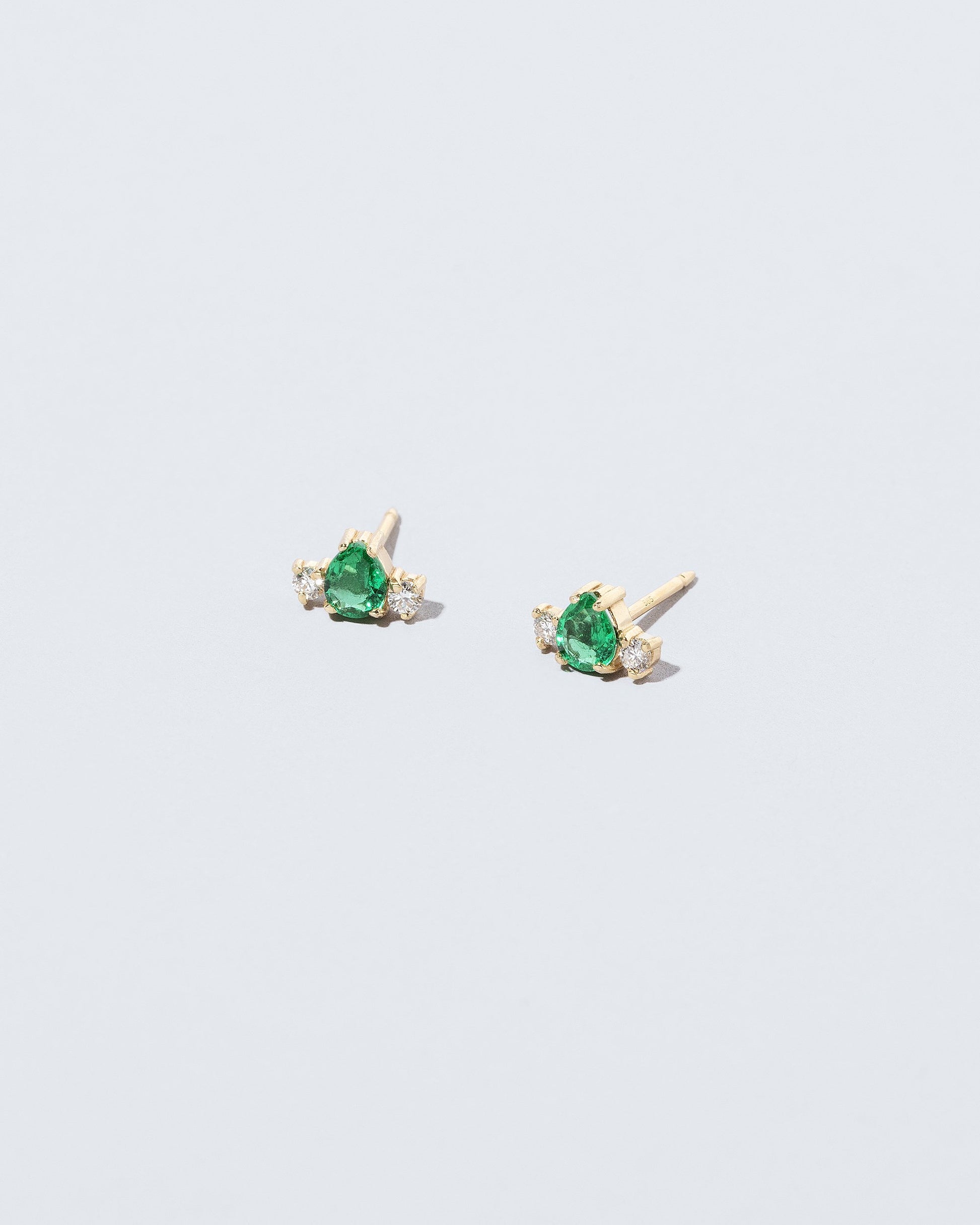 Emerald & Diamond Teardrop Earrings on light color background.