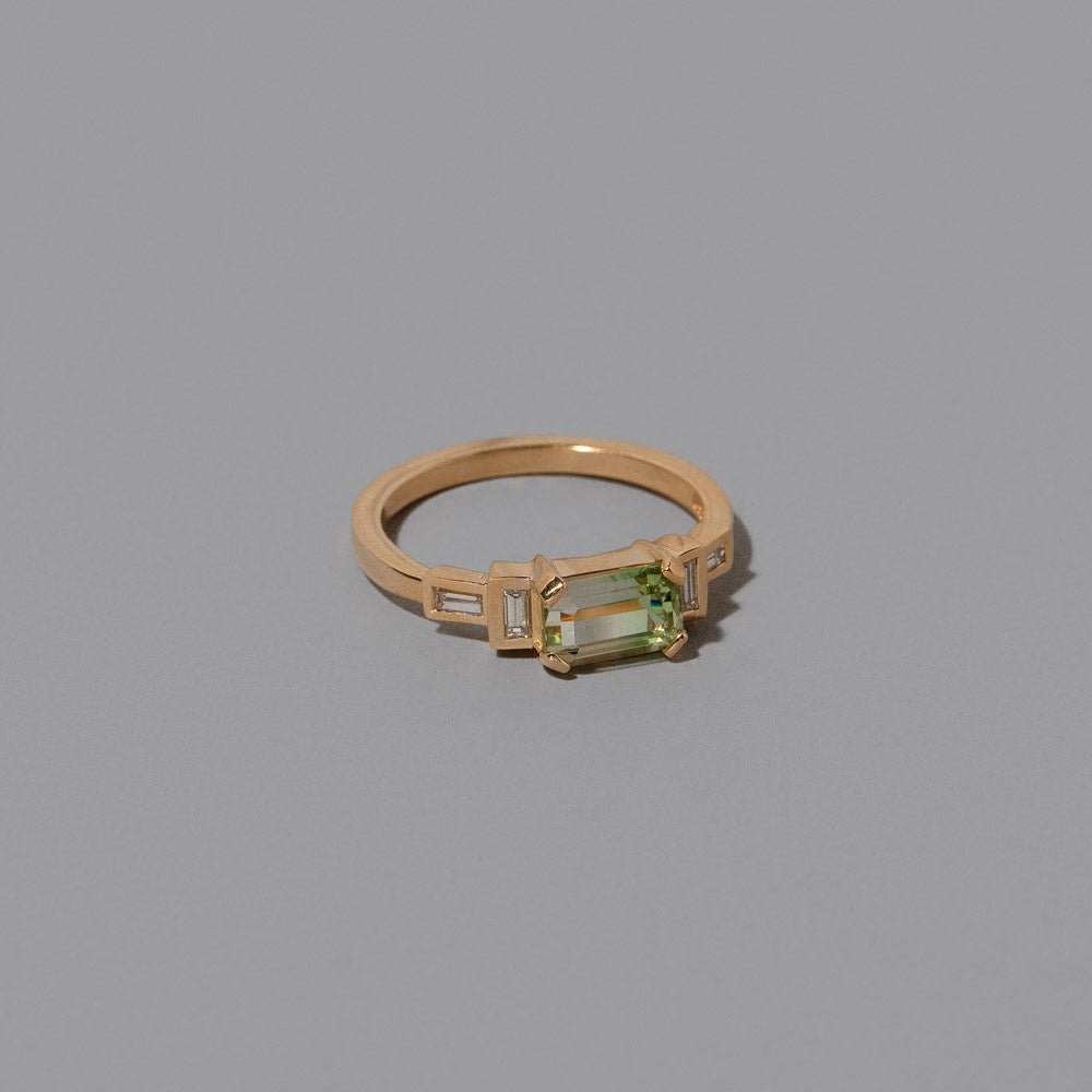 product_details::Closeup details of the Bicolor Garnet Expression Ring on light color background.