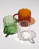 Group of Fazeek Clear, Amber and Green Wave Mugs on light color background.