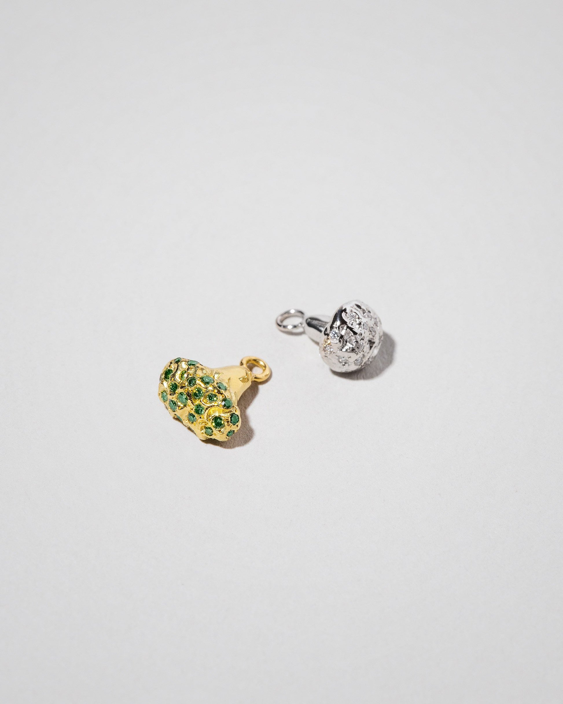 Closeup details of the Cauliflower Charm and Broccoli Charm on light color background.