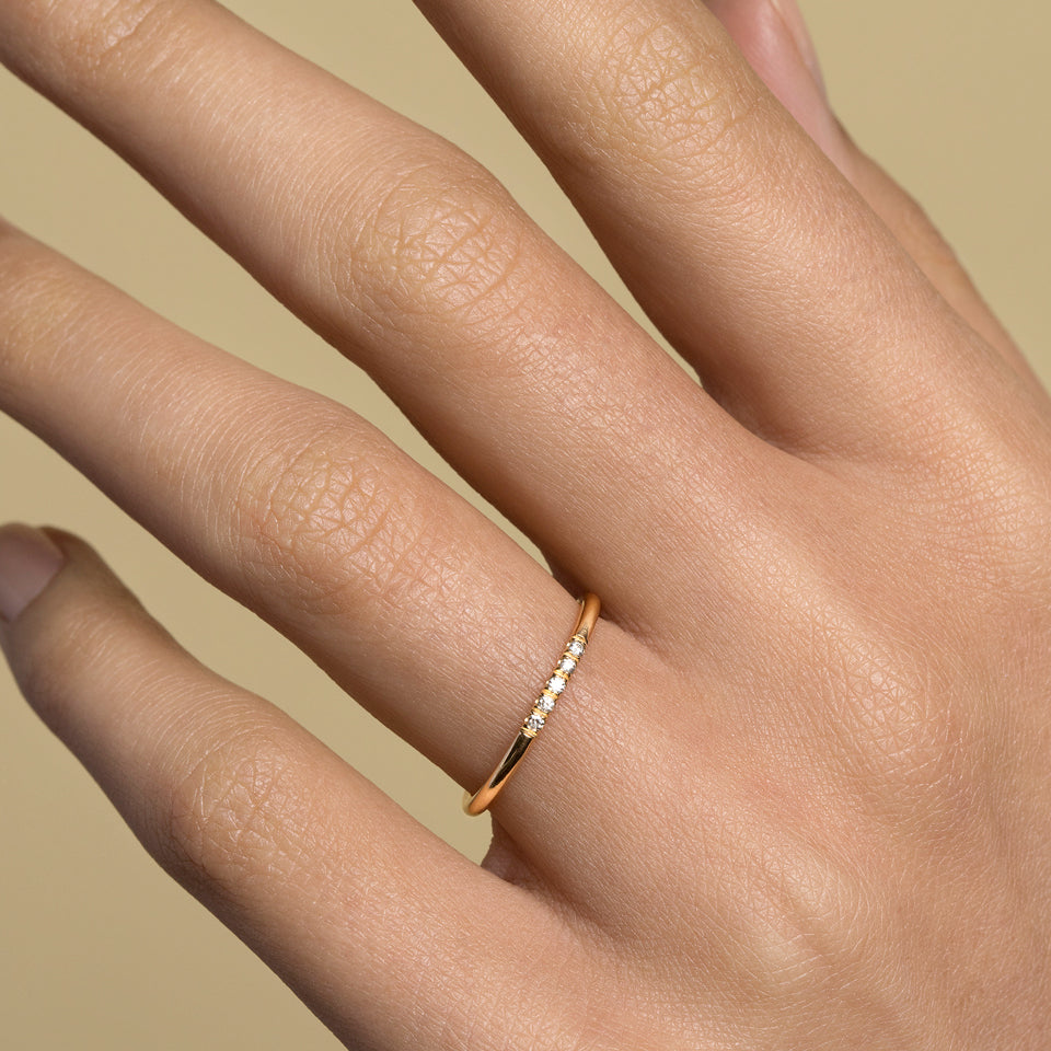 product_details::Gold Five Stone Dot Band on model.