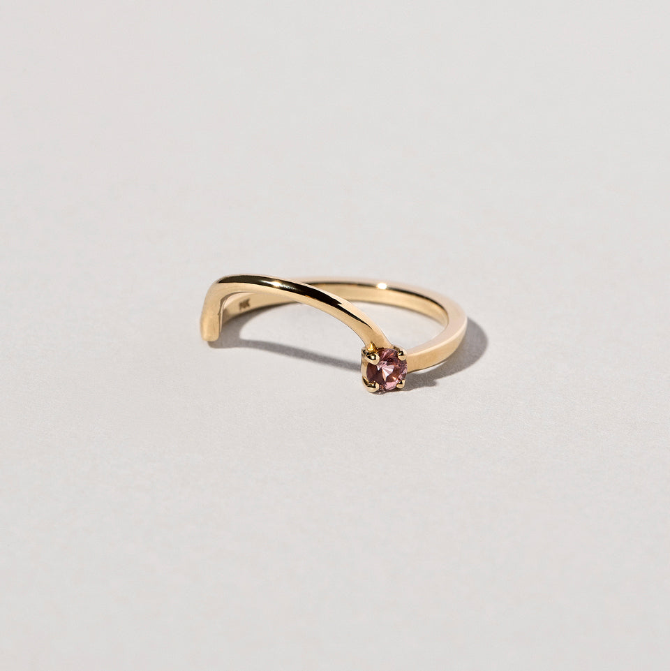 product_details::Closeup detail of the Spinel Gold Half Hoop Band on light color background.
