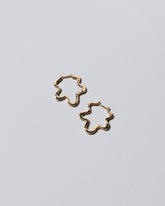 Gold Wild Poppies Hoop Earrings on light color background.