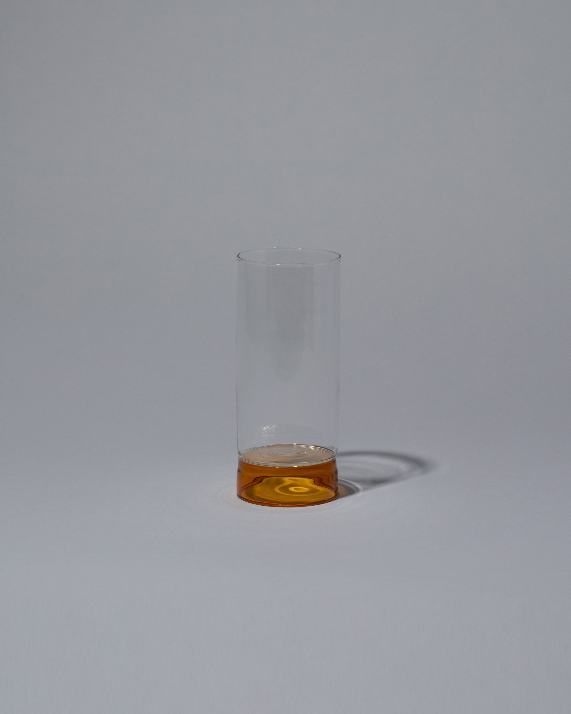Ichendorf Milano Amber/Clear Tall Bamboo Tumbler on light color background.