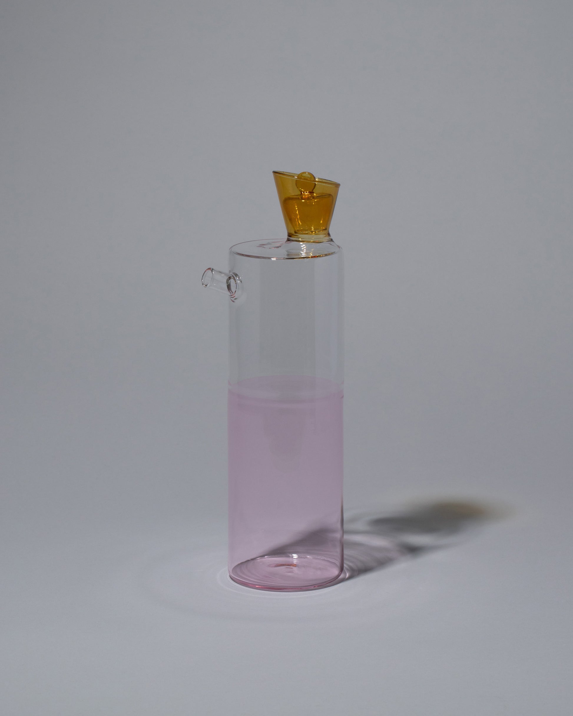 Ichendorf Milano Amber/Clear/Pink Travasi Bottle on light color background.