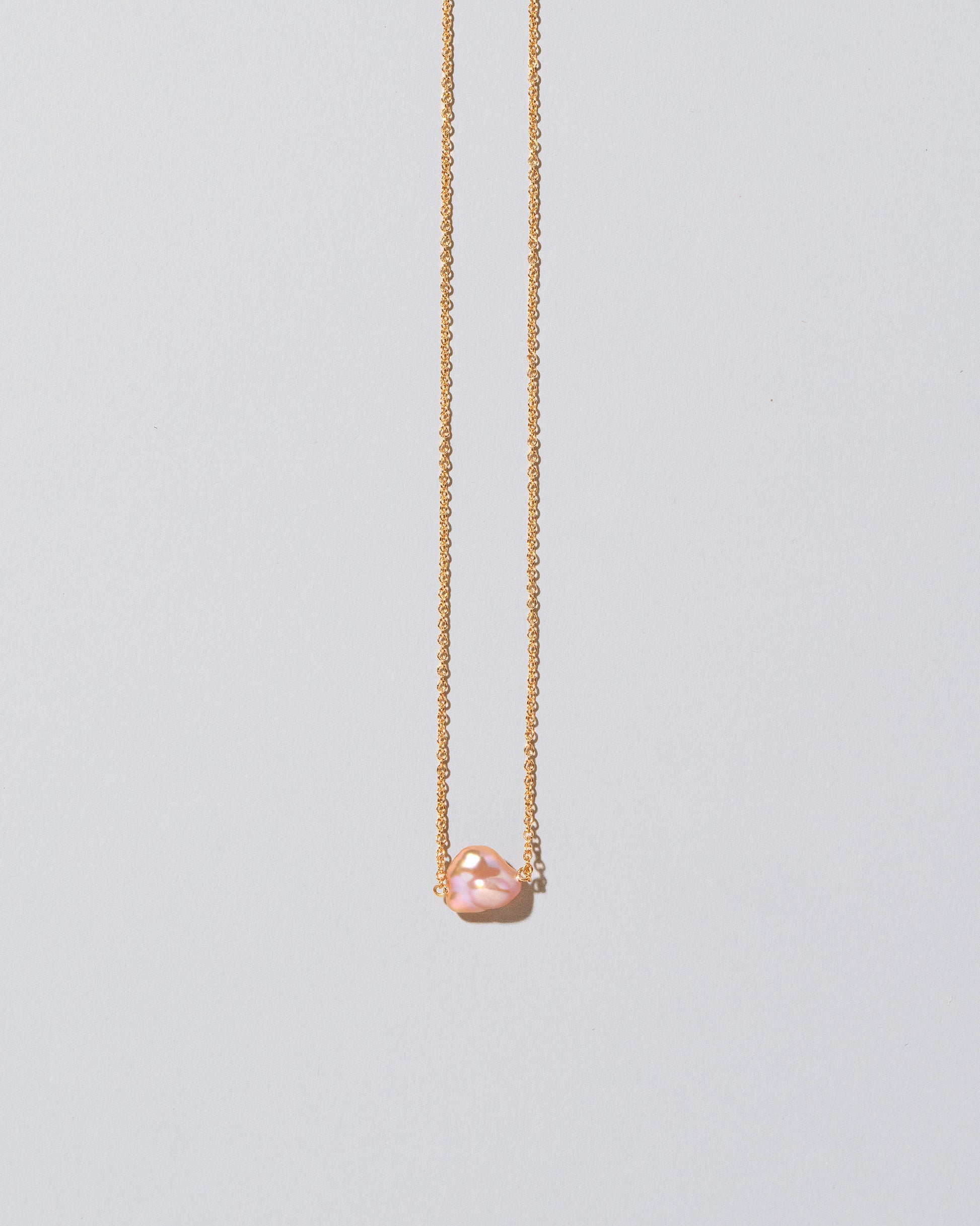 Blush Pink Lagniappe Pearl Necklace on light color background.