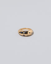 Gold Blue Sapphire Brilliant Cuts Light Cutter Band on light color background.