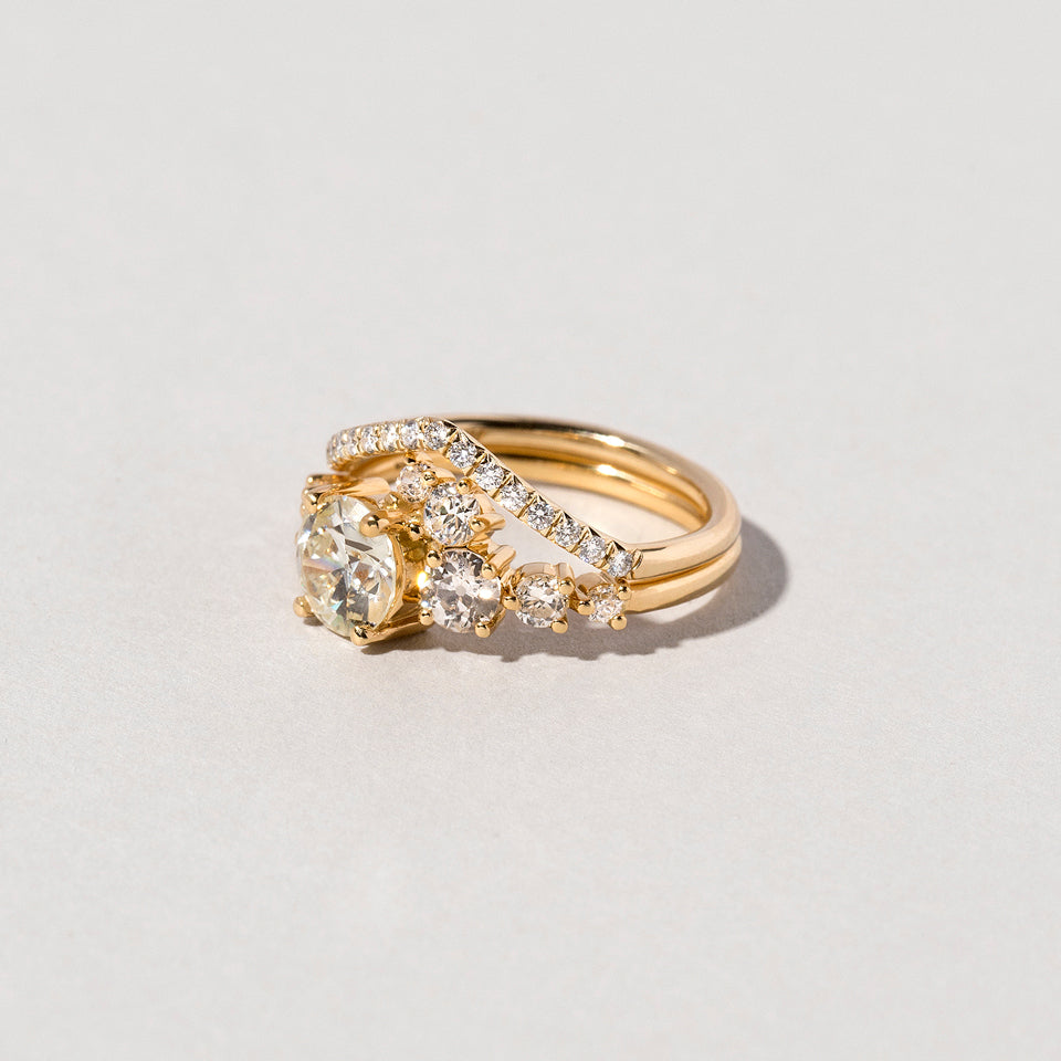 product_details::Luna Ring and White Diamond Pavé Yellow Gold Luna Peak Band on light color background.