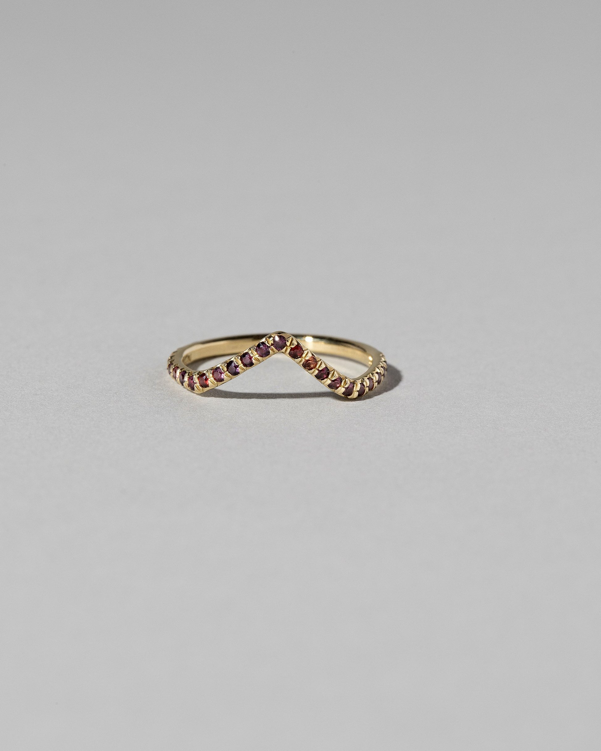 Gold Pavé Garnet High Peak Band on light color background.