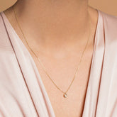 product_details::Diamond Birthstone Necklace on model.