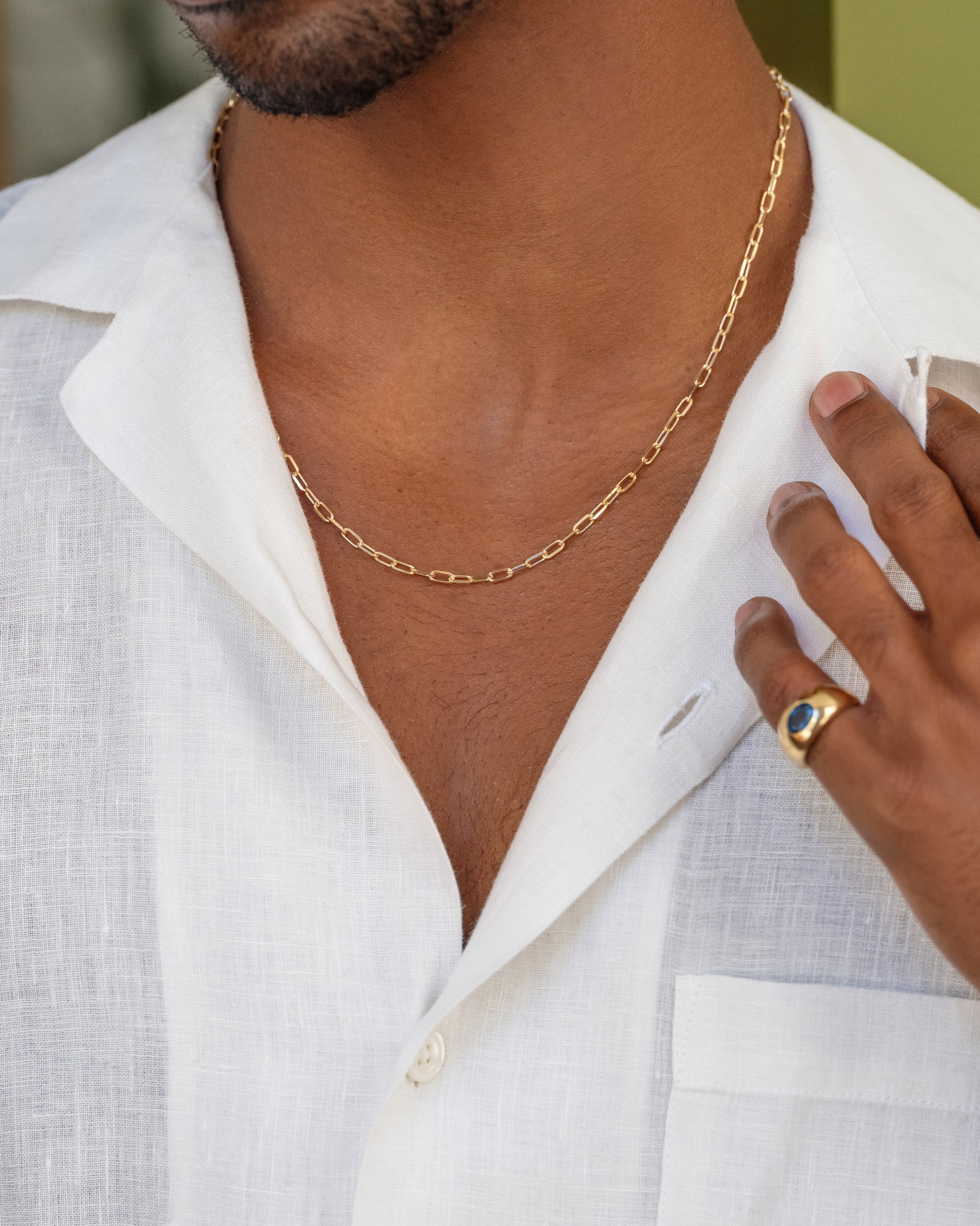 3.5mm Beveled Oval Chain Necklace and Teal Sapphire Jupiter Ring on male model.
