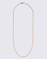 Gold Butter Chain Necklace on light color background.