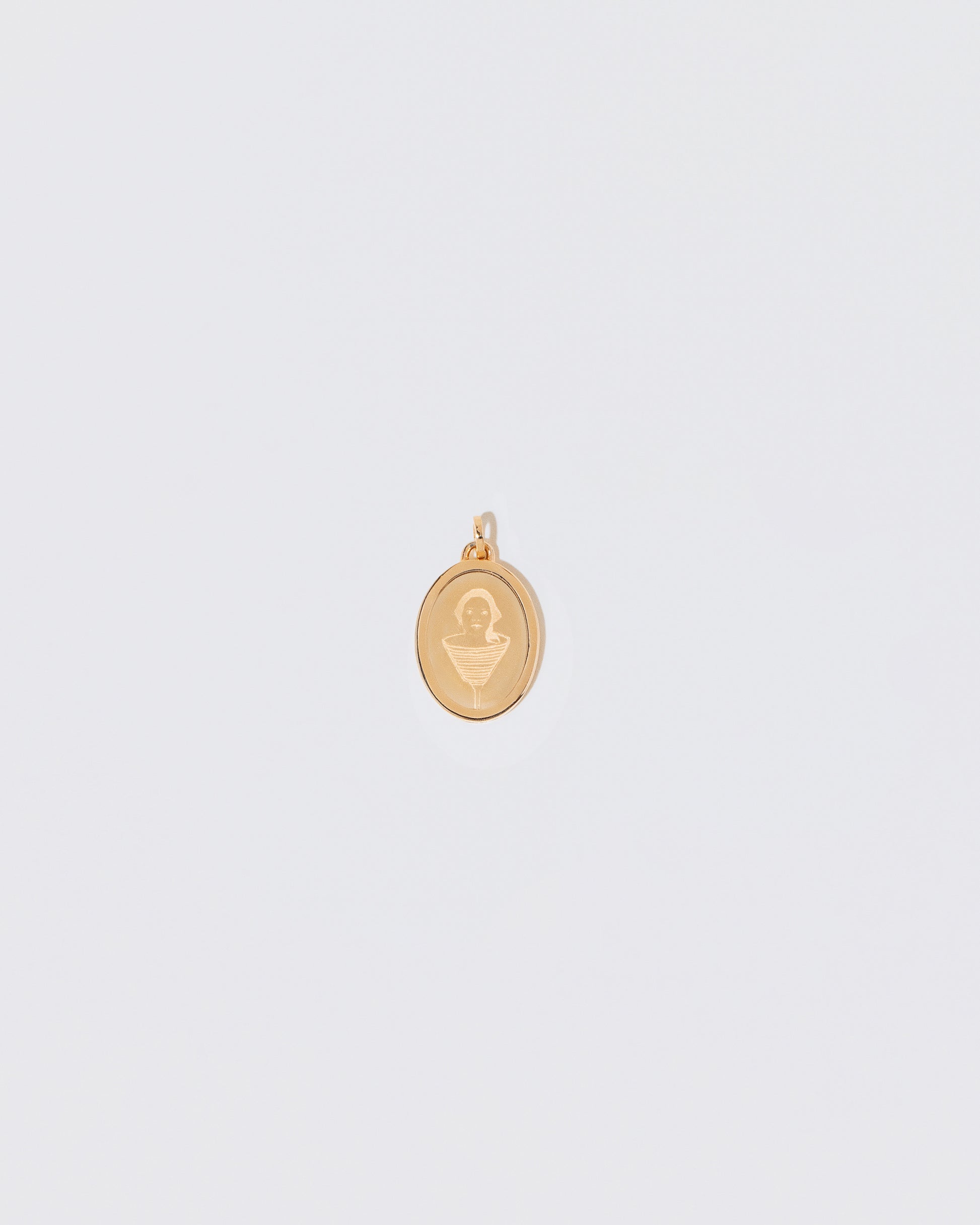 Finished Small Oval Pendant Memento Pendant engraved with a children's drawing on light color background.