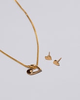 Gold Hearts Necklace & Studs Set on light color bckground.