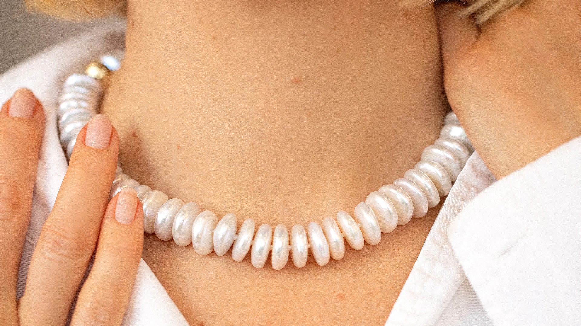 Snow Cap Pearl Necklace on model.