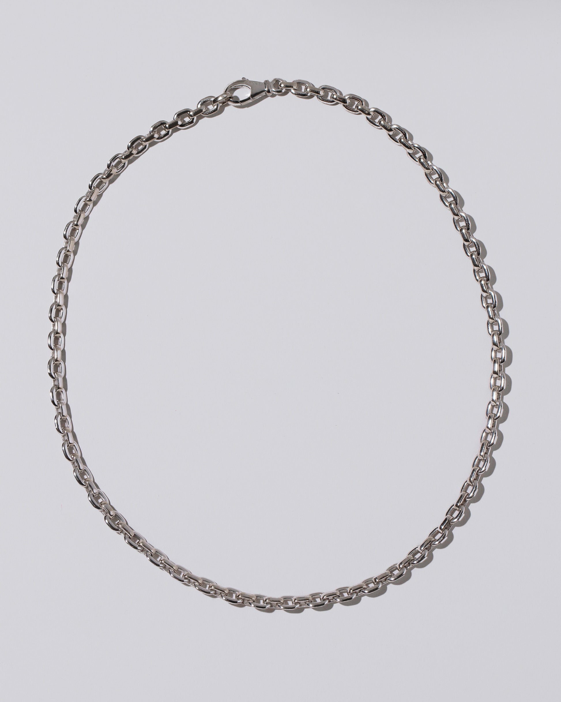 Cartier Oval Cable Chain Necklace on light color background.