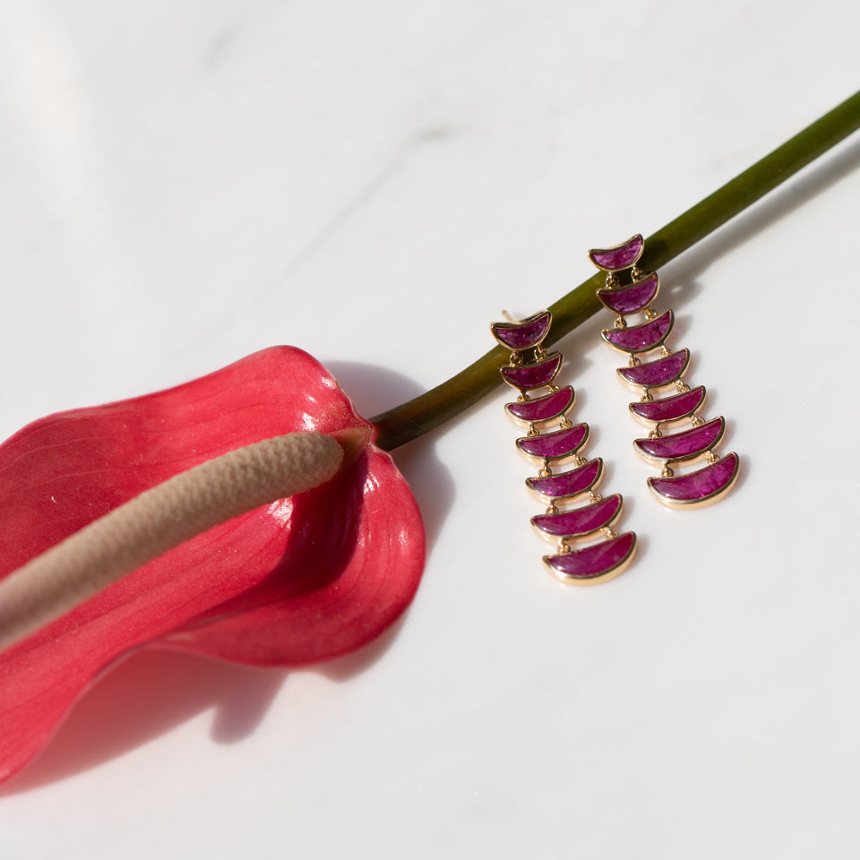 product_details::Editorial photo of the Flame Earrings on light color background.