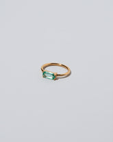 Green Adage Ring on light color background.