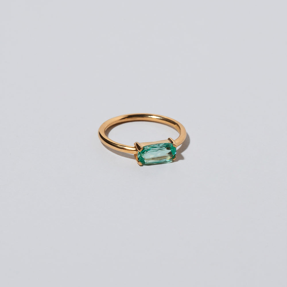 product_details::Green Adage Ring on light color background.
