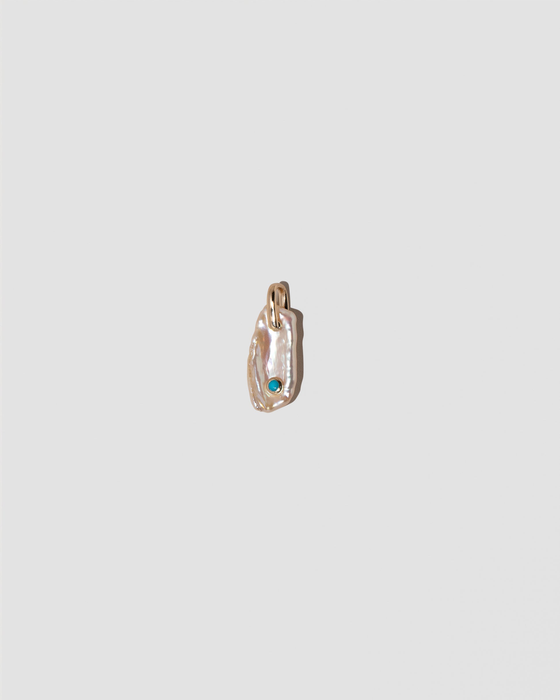 December Birthstone Pearl Pendant With Turquoise on light color background.